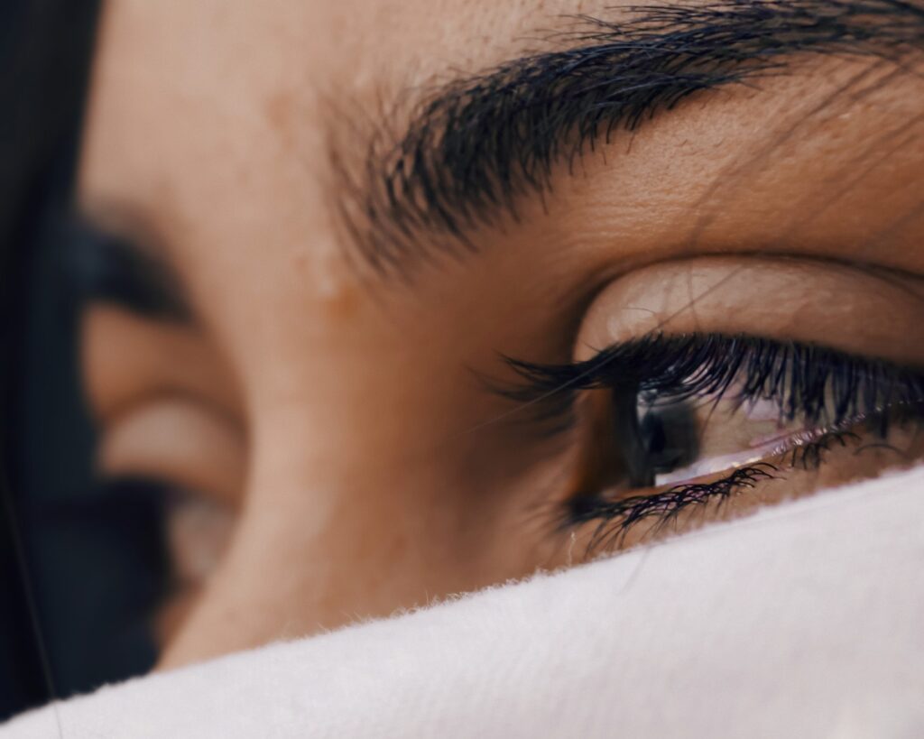 A close up of the eye of a person with a white cloth
